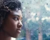 young-woman-looking-out-through-rain-covered-window-768